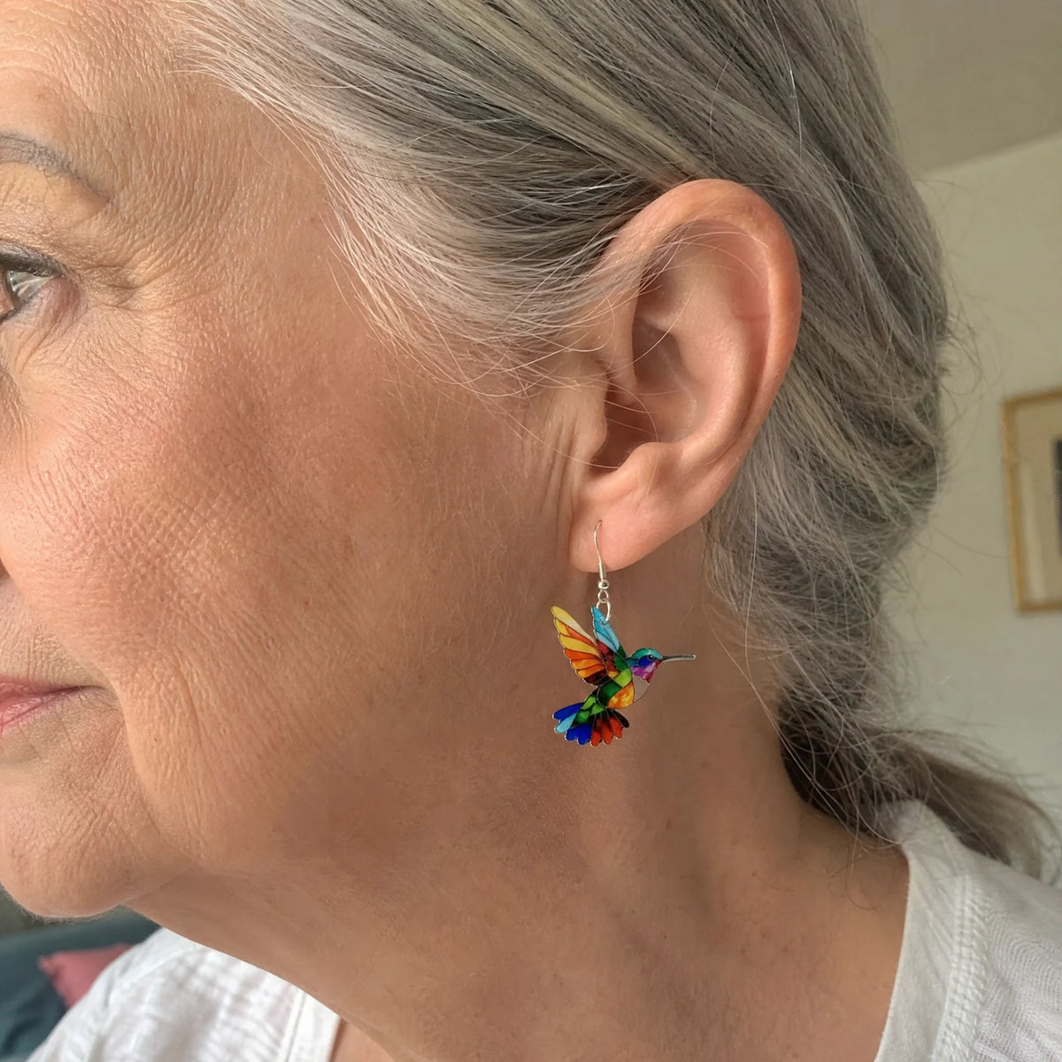 Hummingbird earring worn, shown in profile
