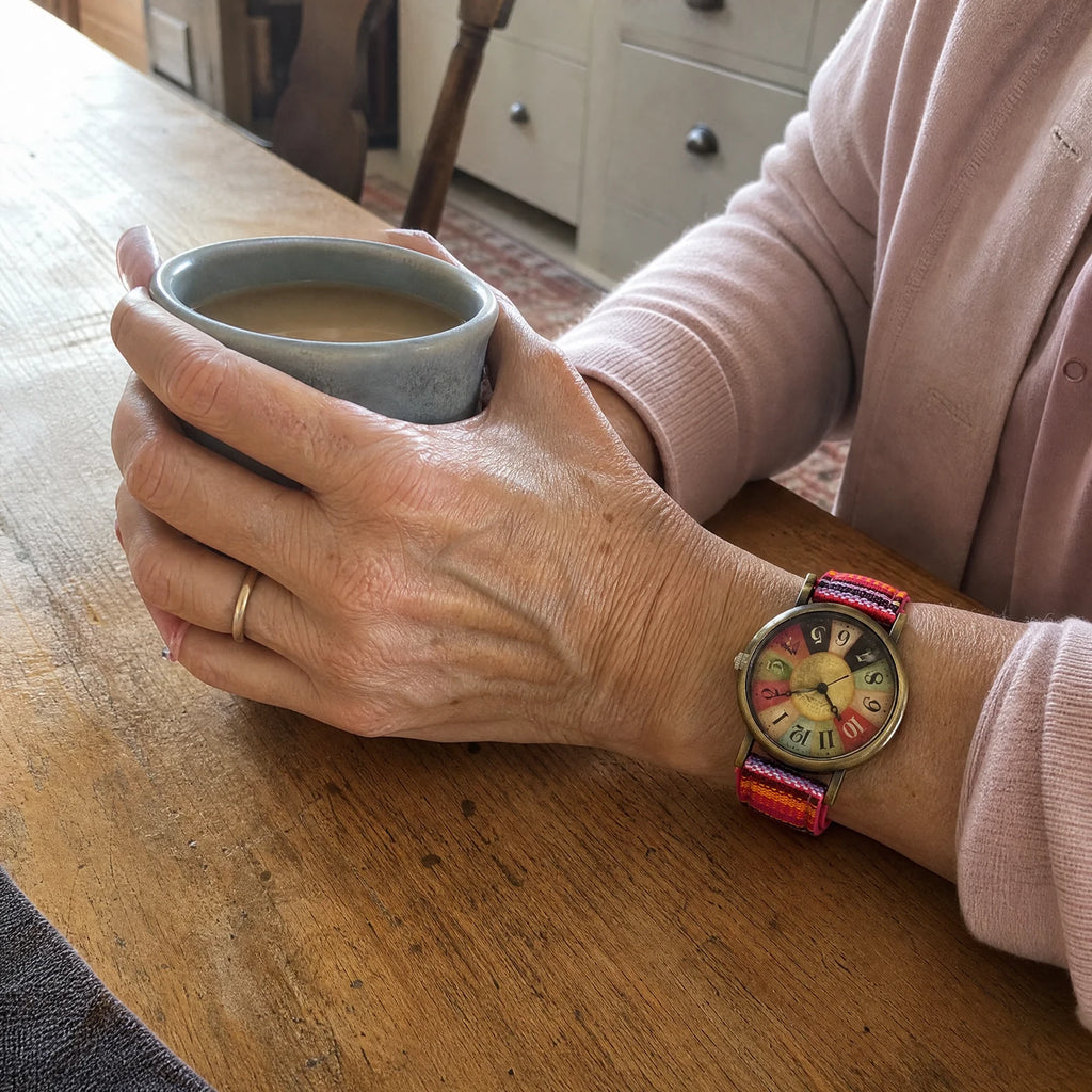 Nora Boho Watch worn on the wrist with a mug of tea